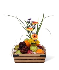 fruit and snacks gift basket with bright blooms