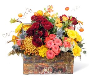 peach, red and yellow fall flowers in tin box