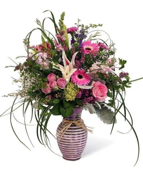 Beautiful lavender vase with shades of purples, pinks and a kiss of white. That is perfect for all occasions. 