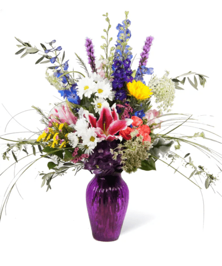Remind someone how much you mean to them by sending her our Violet arrangement. Hydrangea, Lilies and delphinium are just a few of the flowers in this stunning arrangement, that is sure to convey your feelings!